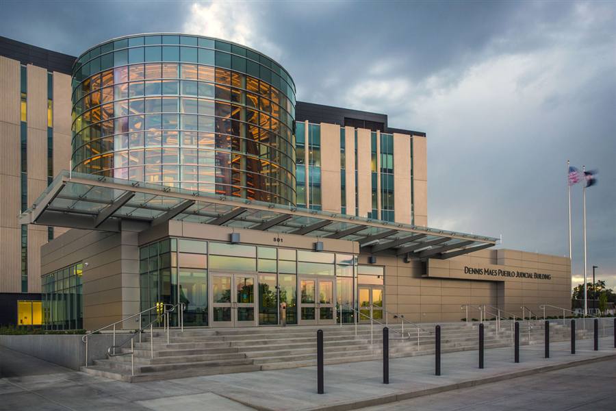 Dennis Maes Pueblo Judicial Building — glass rotunda entrance at dusk