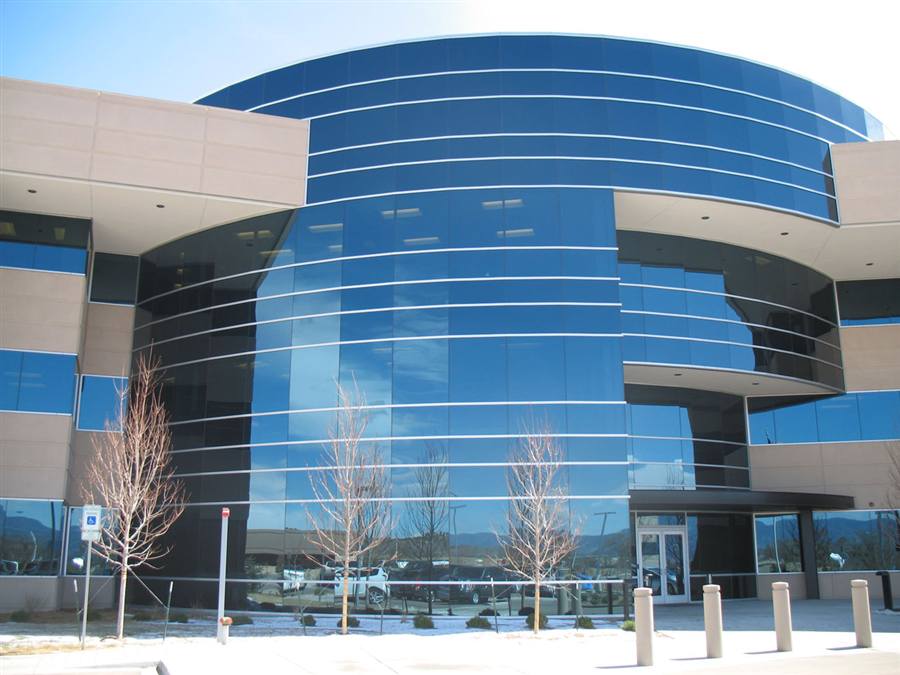 Patriot Park — curved blue glass curtain wall facade